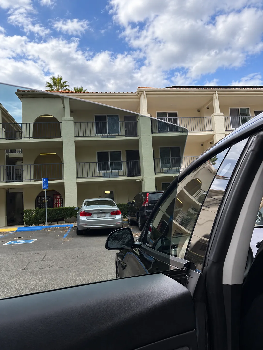 View through a car window at a parking lot